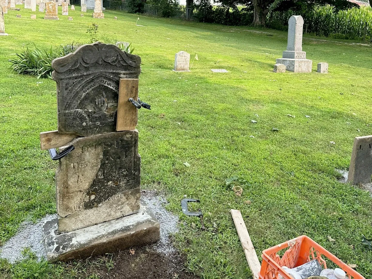 A broken tablet memorial being repaired